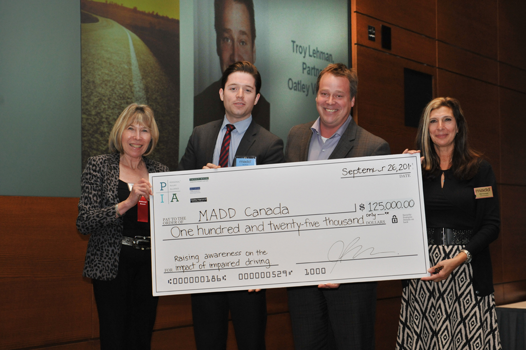 Lawyers from the Personal Injury Alliance present representatives from MADD Canada with a sponsorship cheque at MADD Canada's Sponsor Recognition Dinner. From left to right: Marg Stanowski, Vice-Chair, National Board of Directors MADD Canada; Troy Lehman, Oatley Vigmond; Ian Perry, McLeish Orlando; Angeliki Souranis, MADD Canada National President.